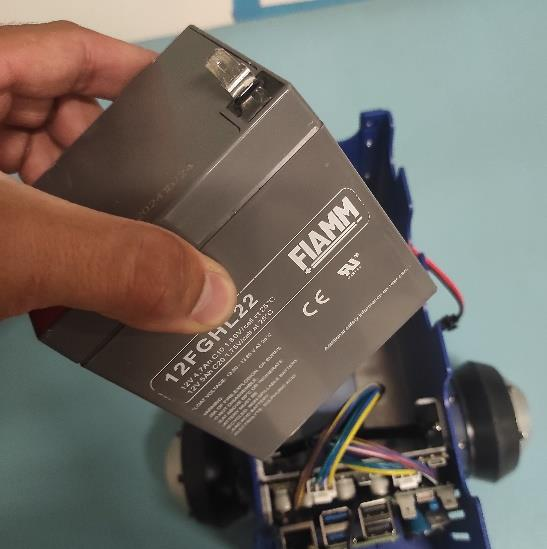 Adding first battery to the robot upper pic 1.