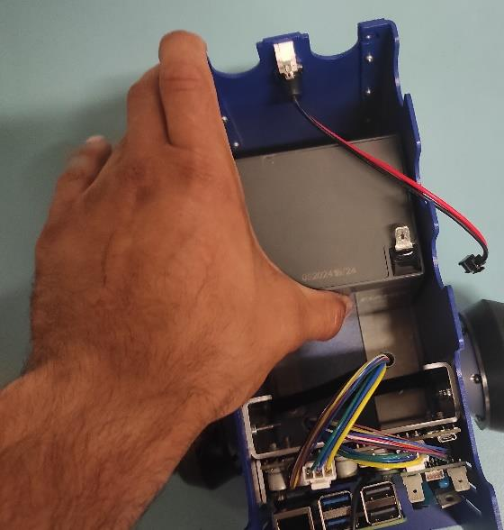 Adding first battery to the robot lower pic 1.