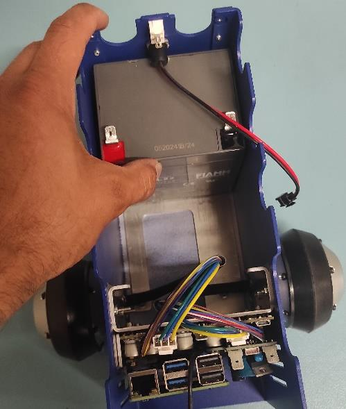 Adding first battery to the robot lower pic 2.
