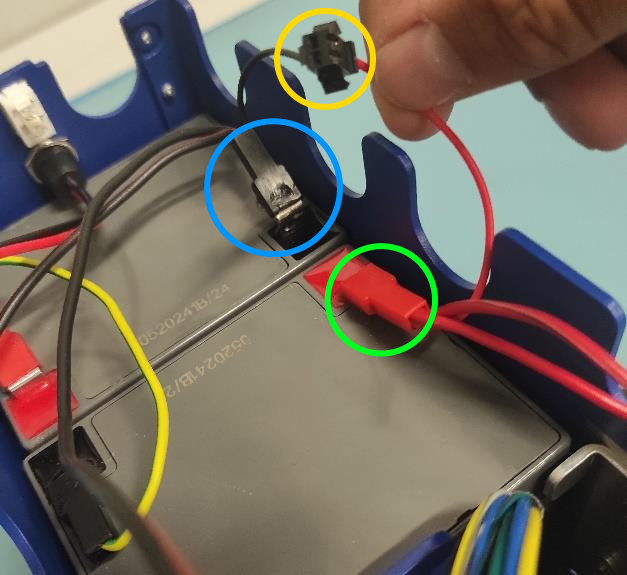 Wires connected to the battery with yellow and green circle. 